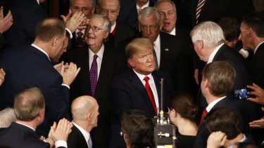 US President Donald Trump, centre, greets attendees ahead of a State of the Union address.