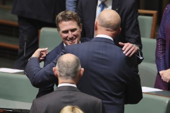 Former attorney-general Christian Porter hugs Defence Minister Peter Dutton following his valedictory speech.