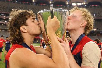 Luke Jackson and Clayton Oliver celebrate with the premiership cup.