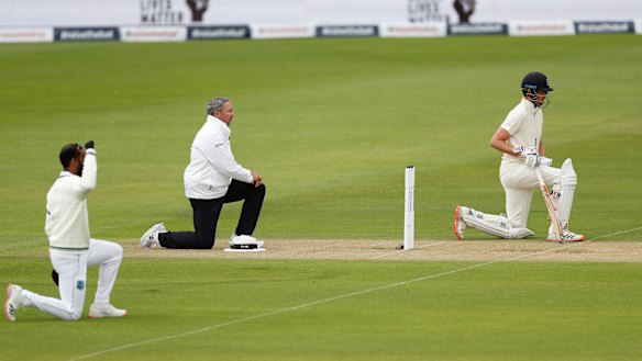 England and West Indian players and the umpires take the knee at the start of the first Test last year.