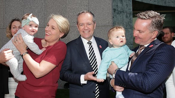 Deputy Opposition Leader Tanya Plibersek holding 10-month-old Lola Farrell, Opposition Leader Bill Shorten and Shadow Treasurer Chris Bowen holding 7-month-old Paul Phillips 