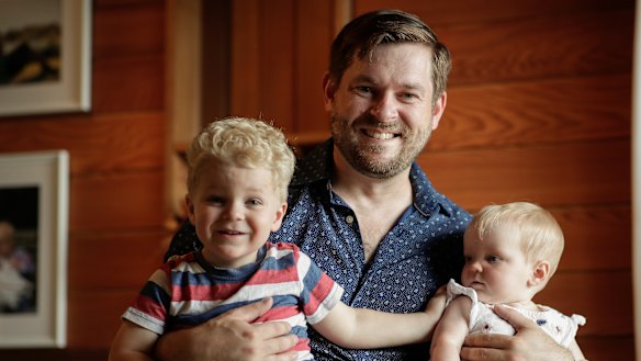 Blake Woodward earlier this year at home with three-year-old son Samuel Woodward and eight-month-old daughter Michaela.