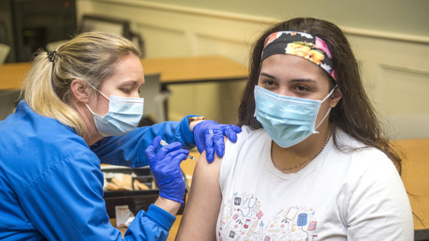 Registered nurse Betty Hallman gives her colleague Norma Elizondo the Pfizer-BioNTech COVID-19 vaccine at University Hospital in Augusta, Georgia in the US.