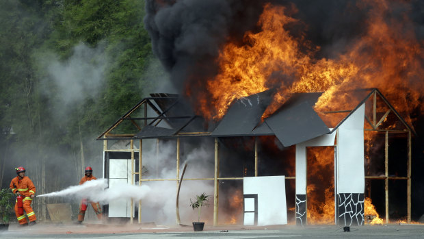 Fire fighters take part in an anti-terrorism drill ahead of the 2018 Asian Games in Jakarta.