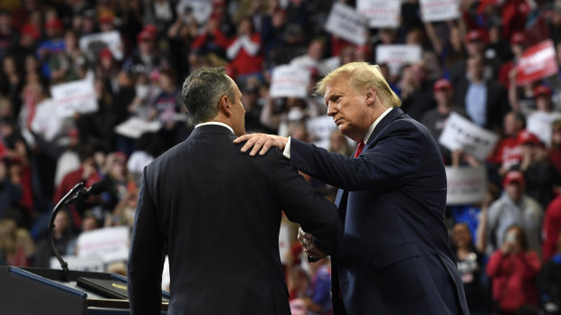 President Donald Trump, left, talks to Kentucky Governor Matt Bevin, right, during a campaign rally in Lexington, Kentucky, on Monday.