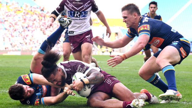 One-way traffic: Jorge Taufua crashes over for Manly.