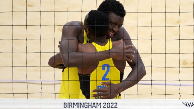 Venuste Gatsinzi, right, hugs teammate Olivier Ntagengwa to celebrate Rwanda’s win in the men’s beach volleyball quarter-final match against New Zealand. 