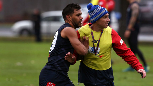 Competitive: Neville Jetta goes up against Melbourne coach Simon Goodwin in training.