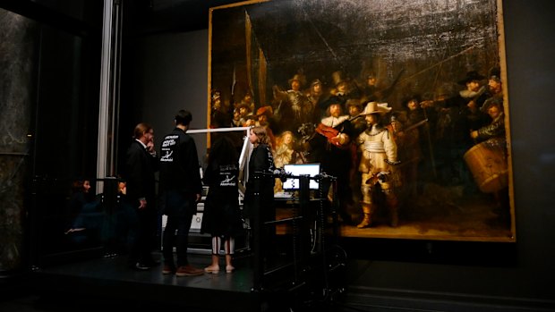 Technicians and researchers check equipment set up inside a glass chamber as they begin to study Rembrandt's 'Night Watch' masterpiece, at the Rijksmuseum in Amsterdam on Monday.