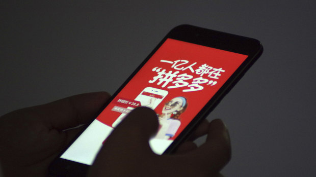 A Chinese customer uses the mobile app of Chinese e-commerce platform Pinduoduo on his smartphone.