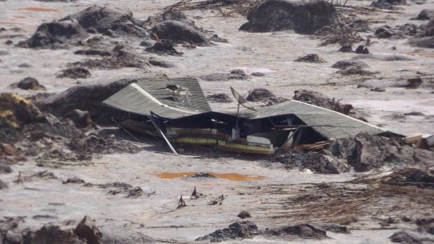 A structure is buried in mud in the Bento Rodrigues valley after BHP-Vale's Samarco dam failure in 2015.