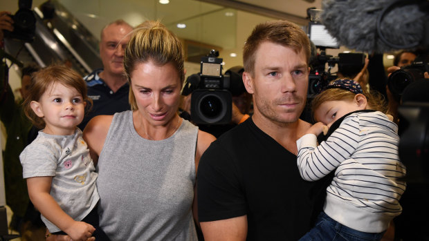 In the eye of the storm: David and Candice Warner return to Sydney with their children in the wake of the ball-tampering scandal.