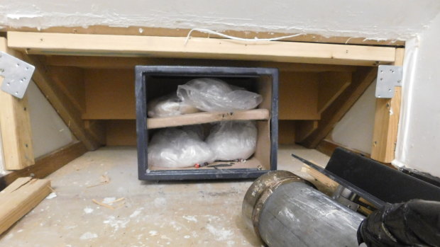 ACT police found ice and heroin with a combined street value of over $2 million in a safe hidden behind a false wall of a Palmerston home.