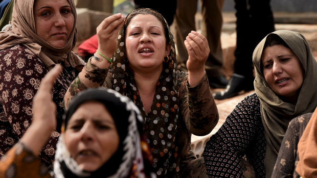 The female relatives of Syrian Democratic Forces soldier Adnan Hassan during his funeral at the Martyr’s cemetery in Bir Kavira. 