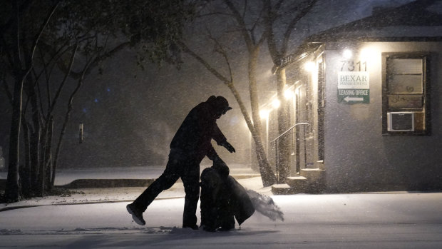 Two people play in the snow in San Antonio.
