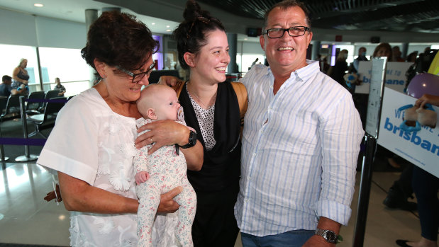 Christine and Michael Preece greet daughter Stephanie and new granddaughter Charlotte after the first flight from Melbourne arrived in Brisbane on Tuesday morning.