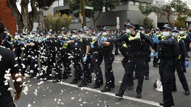 Police use capsicum spray on protestors in Richmond, Melbourne, on Saturday.