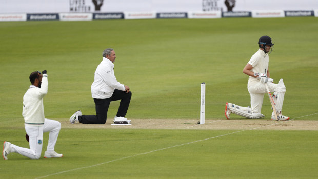 England and West Indian players and the umpires take the knee at the start of the first Test last year.