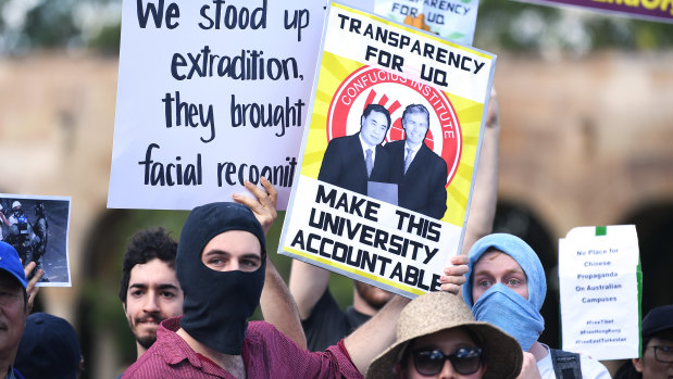 Students hold placards during a protest at the University of Queensland last month. Hundreds gathered to protest against funding agreements between Australian universities and Chinese government-funded education organisations in Queensland.
