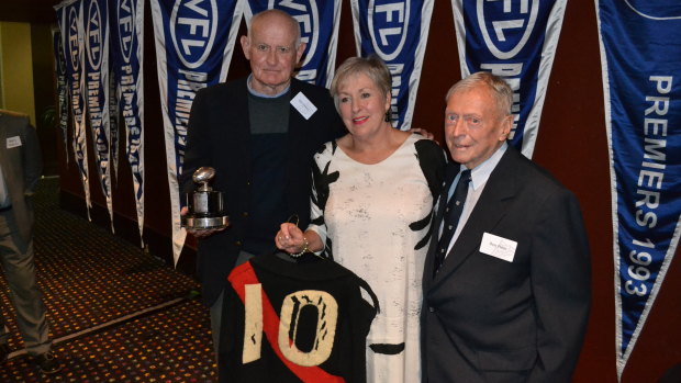 From left: Ken Fraser accepts the rare John Coleman jumper, Coleman's daughter Jenny Goullet, and donor Ron Freer.