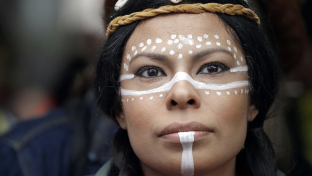 Dr Leslie Jimenez, Hopi Nation member and descendent of Mexican and Ethiopian indigenous peoples, wears traditional celebratory face paint, used to connect to ancestors, during an Indigenous Peoples Day blessing in Seattle on Monday.