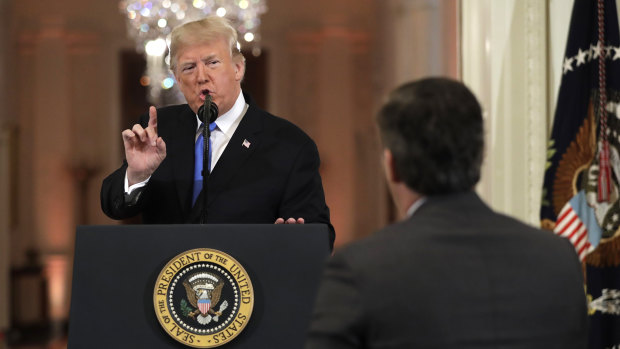 President Donald Trump speaks to CNN White House correspondent Jim Acosta during the news conference.