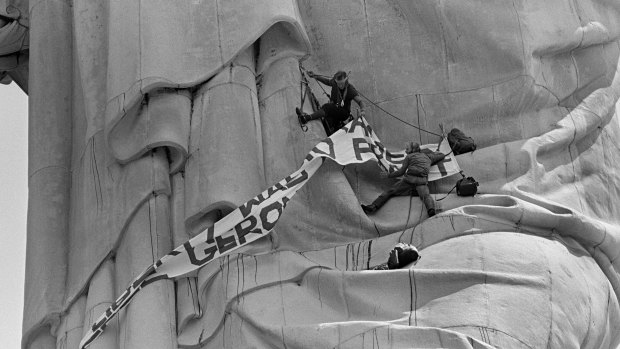 Edwin Drummond, top, and Stephen Rutherford climb a third of the way up the Statue of Liberty in New York Harbor.
