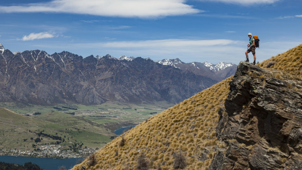 A hiker looks over Lake Wakatipu to the Remarkables on New Zealand's South Island.