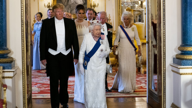 Trump and first lady Melania Trump walk with the Queen.