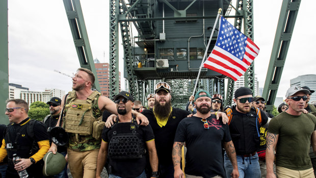 Members of the Proud Boys and other right-wing demonstrators march across the Hawthorne Bridge in Portland, Oregon, in August.