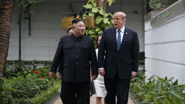 Donald Trump and Kim Jong-un take a walk after their first meeting in Hanoi.