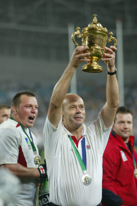 Clive Woodward holds the 2003 Rugby World Cup trophy aloft.