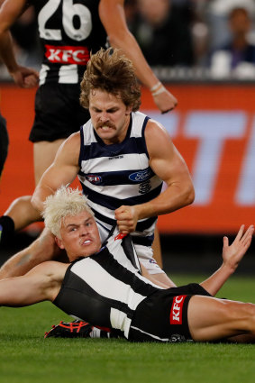 Geelong’s Tom Atkins was penalised for throwing Jack Ginnivan to the ground. 
