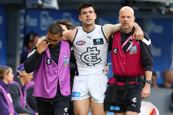 Matthew Kennedy is helped from the field on Sunday. 