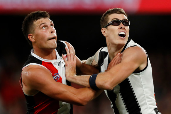 Mason Cox, right, pictured wearing prescription glasses, competes for the ball with Rowan Marshall. 