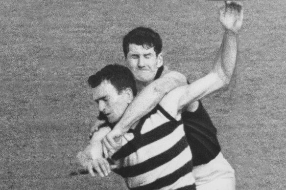 Paddy Guinane gets to grips with Geelong's Geoff Ainsworth during the 1967 grand final.