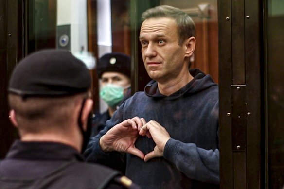 Alexei Navalny stands in the defendants’ cage during a hearing into his 2014 criminal conviction in Moscow.