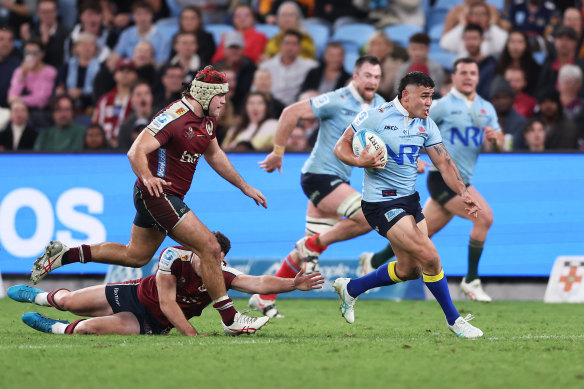 Izaia Perese makes a break for the Waratahs against the Reds on Friday night.