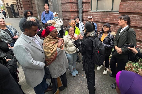 Public housing tenants gather outside the Supreme Court on Friday morning.