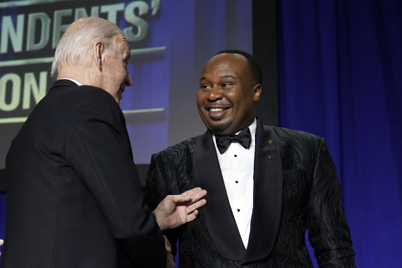 President Joe Biden shakes hands with comedian Roy Wood jnr after his roast at the dinner.