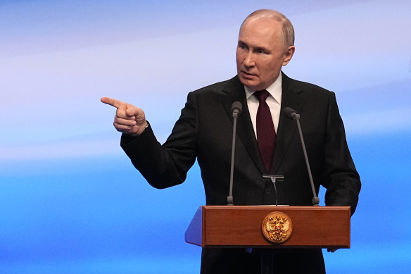 Russian President Vladimir Putin gestures while speaking on a visit to his campaign headquarters on Monday.
