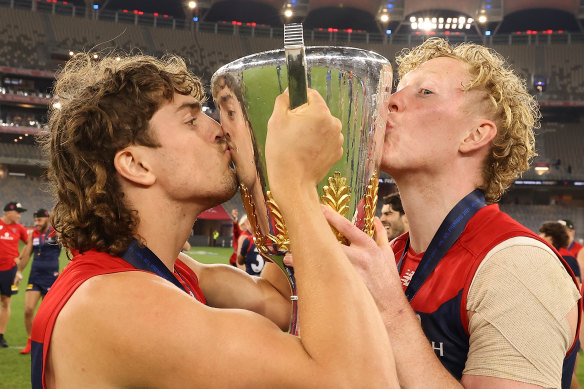 Luke Jackson and Clayton Oliver celebrate with the premiership cup.