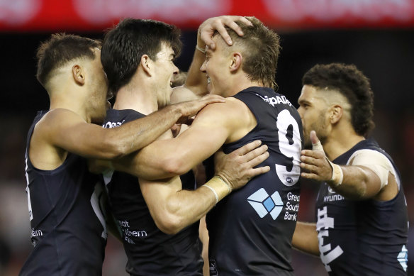 Patrick Cripps and the Blues celebrate a goal.