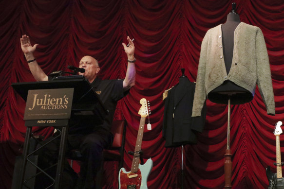 Auctioneer David Kruse during the sale of a cardigan worn by Kurt Cobain at an auction of rock memorabilia held at the Hard Rock Cafe, New York. 