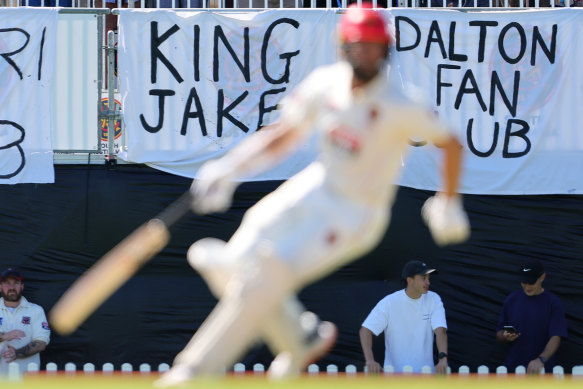 Jake Lehmann and the banner in his honour.
