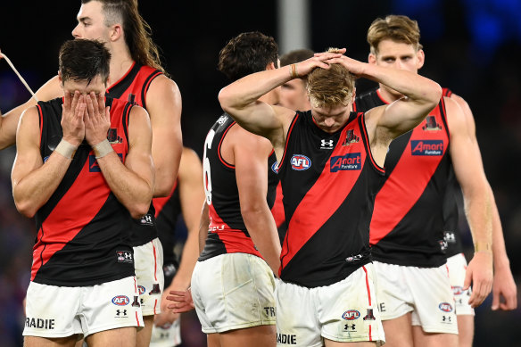 A dejected Essendon leave the field after their loss to the Western Bulldogs.