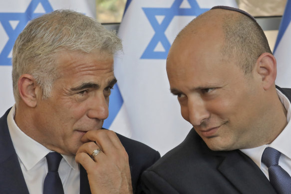 Israeli Prime Minister Naftali Bennett, right, has ceded his role to Foreign Minister Yair Lapid until the election in Autumn.