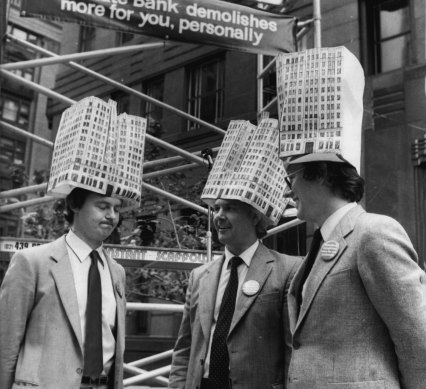 Architects Ian Stapleton, Dick Rowe and Howard Tanner demonstrate outside the Rural Bank, March 25, 1982.