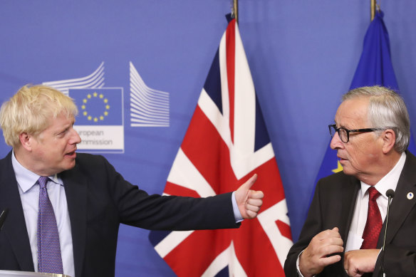 British PM Boris Johnson, left, gestures towards Jean-Claude Juncker, president of the European Commission.