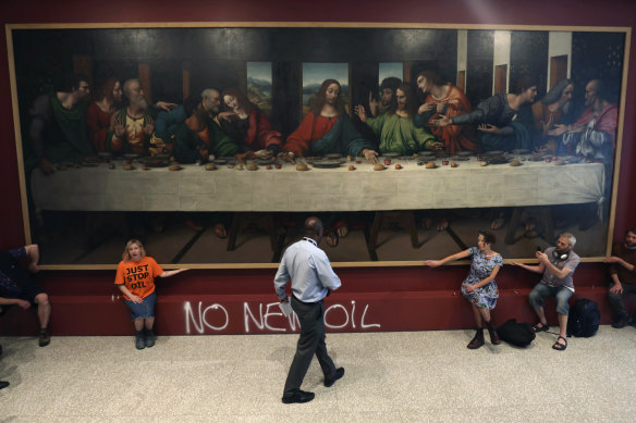 Protesters from “Just Stop Oil” climate protest group glue their hands to the frame of a copy of Leonardo da Vinci’s, ‘The Last Supper’, inside the Royal Academy, London.